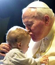 FILE -- Pope John paul II kisses an unidentified baby at the end of a general weekly audience in the Pope Paul VI hall at the Vatican, Wednesday, March 14, 2001. Pope John Paul II, the Polish pontiff who led the Roman Catholic Church for more than a quarter century and became history's most-traveled pope, has died at 84, the Vatican announced Saturday, April 2, 2005. (AP Photo/Plinio Lepri)