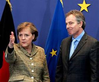 British PM Blair is welcomed by German Chancellor Merkel at a two-day EU leaders summit in Brussels