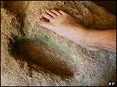 Foot-shaped niche in cave
